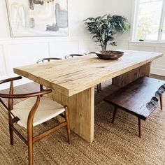 a wooden table with two chairs and a bowl on it