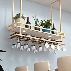 a rack with pots and pans hanging from it's side in a dining room