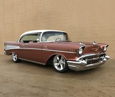 an old classic car parked in front of a building