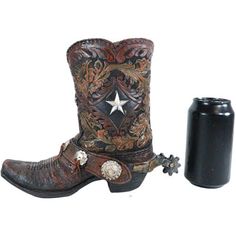 a pair of cowboy boots next to a black bottle on a white background with an image of a star in the center