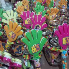 there are many hand shaped candy in the jars on the table, and one is for sale