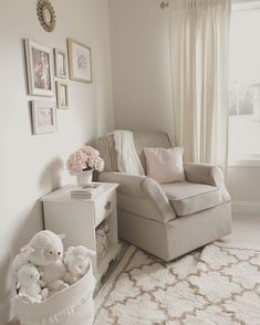 a baby's room with a chair, dresser and teddy bear in the corner