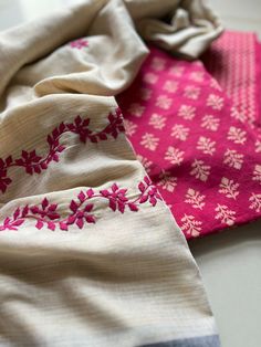 three pieces of cloth with pink and white flowers on them are laying next to each other