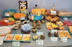 a table filled with lots of food and desserts