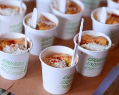 several cups filled with food sitting on top of a table