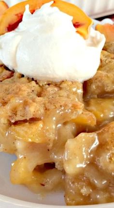 a slice of peach cobbler with whipped cream on top