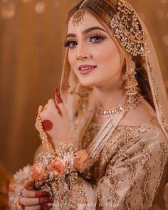 a woman in a bridal outfit with flowers on her head