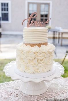 a wedding cake with the word love on top