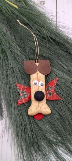 a dog ornament hanging from a christmas tree