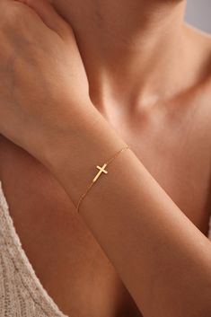 DAINTY CROSS  BRACELET *  GOLD CROSS BRACELET * Introducing our elegant 14K Gold Cross Bracelet, a timeless piece of dainty cross jewelry that exudes grace and sophistication. This beautiful religious bracelet features a delicate cross charm, making it a perfect accessory for women who cherish their faith. Crafted from high-quality 14K gold, this cross bracelet is designed to be both durable and stunning, ensuring it can be cherished for years to come. The minimalist design makes it versatile en Everyday Gold Cross Bracelets, Gold Cross Bracelets For Everyday, Gold Cross Bracelet For Everyday Wear, Gold Cross Bracelets For Gifts, Gold Cross Bracelet, Silver Cross Bracelet, Christian Gifts For Women, Cross Bracelet, Cross Jewelry