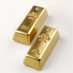 two gold bars sitting next to each other