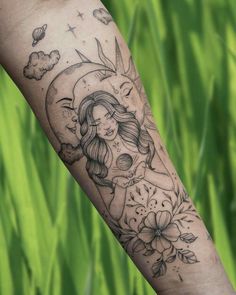 a woman's arm with flowers and a half moon tattoo on her left forearm