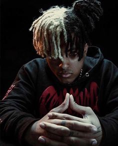 a man with dreadlocks sitting at a table