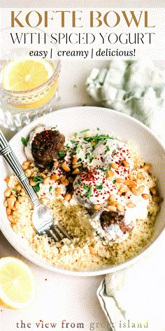 a white bowl filled with food next to lemon slices