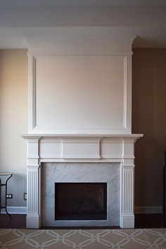 an empty living room with a fireplace in it