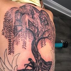 a woman with a tree tattoo on her back