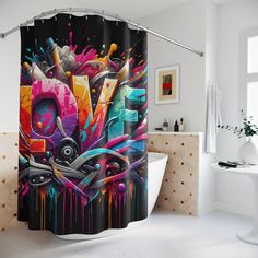 a colorful shower curtain with an abstract painting on it's side in a bathroom