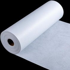 a roll of white paper sitting on top of a table