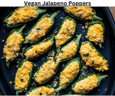 some green peppers with cheese on top and the words vegan jalapeno poppers