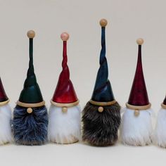 seven gnome hats are lined up on top of each other