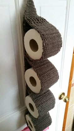 three rolls of toilet paper are hanging on the wall next to each other in front of a door