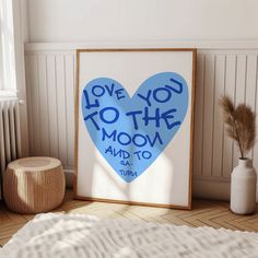 a blue heart shaped poster with the words love you to the moon and back