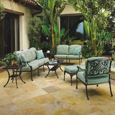 an outdoor living room with blue and green furniture