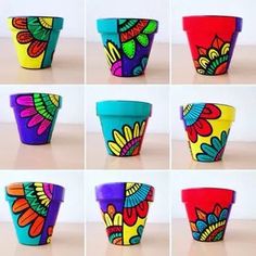 many different colored cups with designs on them