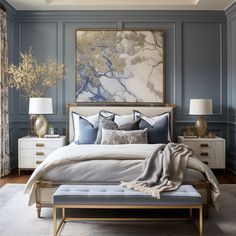 a bedroom with blue walls and white bedding, gold accents on the headboard