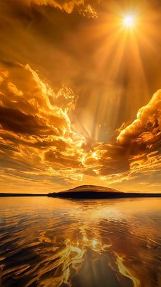 the sun is shining brightly over water with clouds and land in the foreground,