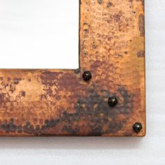 an old rusted metal frame with rivets and holes in the middle on a white background