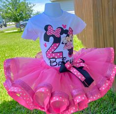 a minnie mouse birthday outfit with pink and white polka dot tutule, matching t - shirt and headband