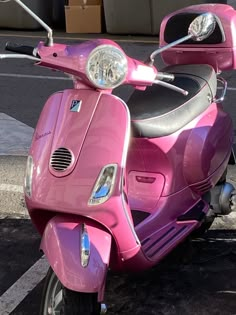 a pink scooter is parked on the street