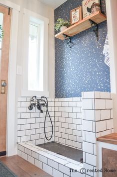 a bathroom with blue and white wall tiles