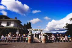 a group of people that are standing in front of some barrels