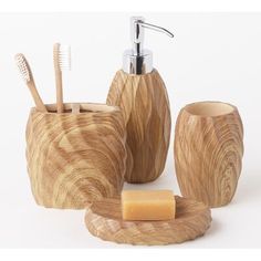 wooden bathroom accessories including soap dispenser, toothbrush holder and soap dish