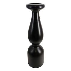 a black vase sitting on top of a white table