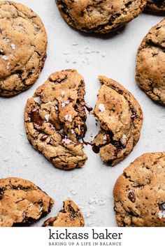 chocolate chip cookies on a baking sheet with the words kickass baker baking up a life in balance