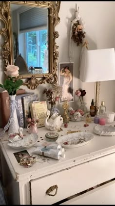 an antique dresser is covered with vintage items