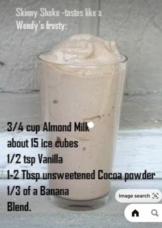 a tall glass filled with ice cream on top of a table