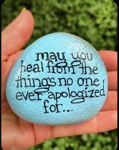 a hand holding a rock with the words may you heal from the things no one ever apoloized for