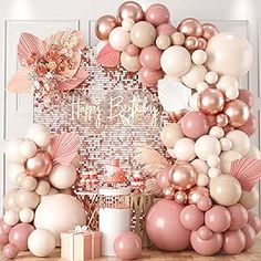 a pink and white birthday party with balloons, confetti garlands and decorations