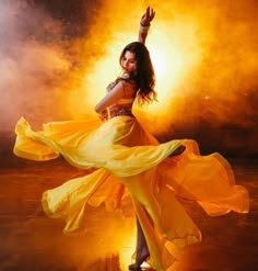 a woman in a yellow dress is dancing