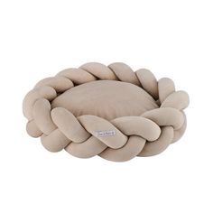 the rope dog bed in beige is made out of thick fabric and has a round shaped cushion