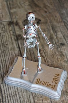 a skeleton figurine standing on top of a piece of paper that says scaffest