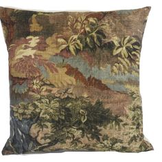 a decorative pillow with trees and flowers on it