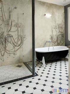 a black and white bathroom with chandelier in the shower, tub and sink