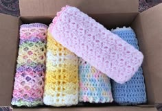 four crocheted items in a box on the floor