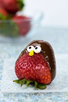 a chocolate covered strawberry sitting on top of a counter