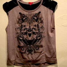 Fun Rocker Tee By Bongo Featuring A Skull/Rock Design With Black & Metal Stud Embellishments. Taupe Color With Faux Leather Across Shoulders And Back With Buckle Design. Looks Never Worn. Size Xl. Pit To Pit 21”. Shoulder To Hem 24” Brown Leather Casual Tops, Casual Brown Leather Top, Casual Brown Leather Tops, Leather Short Sleeve Tops For Fall, Casual Black Leather Top, Casual Leather Tops With Short Sleeves, Casual Leather Top With Short Sleeves, Casual Leather Short Sleeve Tops, Casual Short Sleeve Leather Top